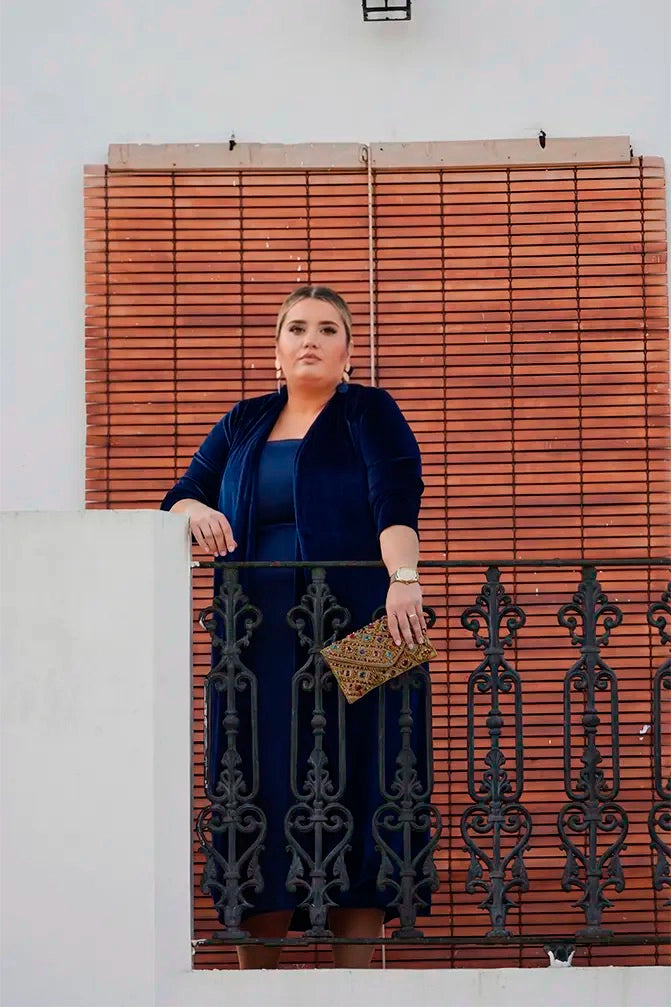MUJER EN BALCON CON VESTIDO DE TALLA GRANDE Y CHAQUETA DE TERCIOPELO