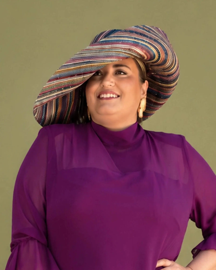 Pamela de rafia multicolor Magda de ala ancha combinada con vestido de gasa buganvilla, modelo talla grande sonriendo, look de invitada Pamela de rafia multicolor Magda de ala ancha combinada con vestido de gasa buganvilla, modelo talla grande sonriendo, look de invitada